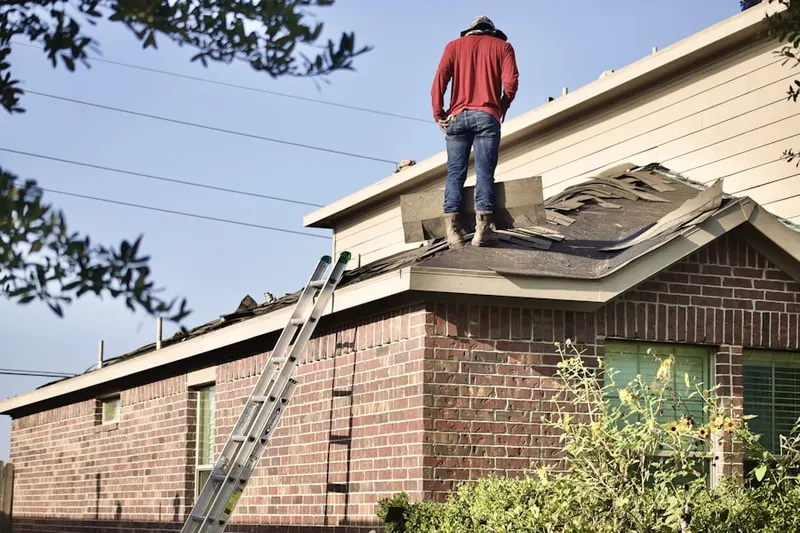 Professional roofer working on a residential roof in Pearson Estates